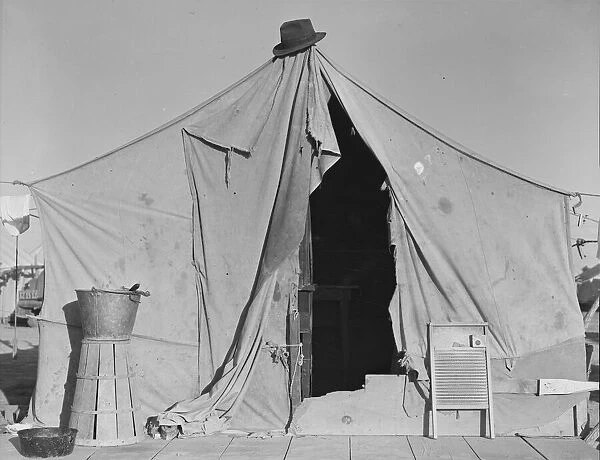 One of a row of tents, home of a pea picker, near Calipatria, Imperial Valley, California, 1939. Creator: Dorothea Lange