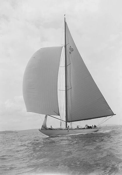Sailing yacht Trivia running downwind under spinnaker, 1939. Creator: Kirk & Sons of Cowes