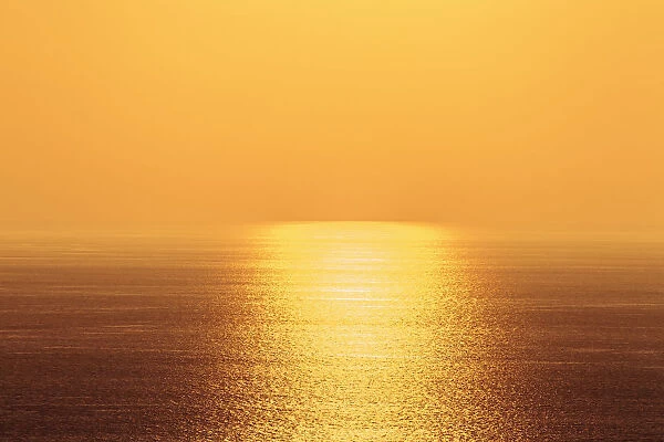 Golden Sky And Sunlight Setting Over The Pacific Ocean; Island Of Hawaii, Hawaii, United States Of America