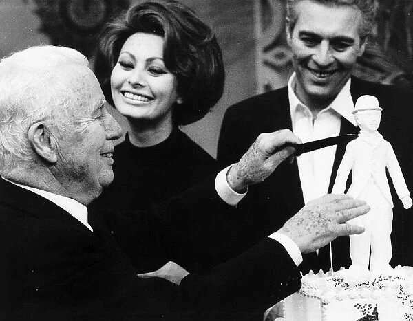 Charlie Chaplin Actor Celebrating his 77 birthday cutting a cake with Sophia Loren