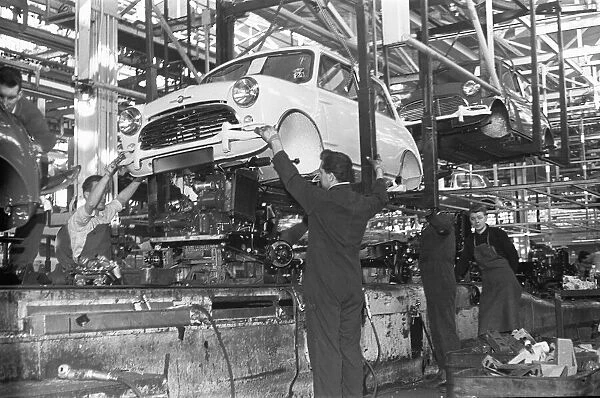 The engine is fitted to a Austin Mini on the production line, Longbridge. 10th March 1963