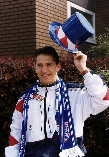 England footballer Gary Lineker wearing shellsuit and holding top hat in national colours