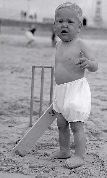 The next Jack Hobbs stands at the crease ready to bat in a game of beach cricket