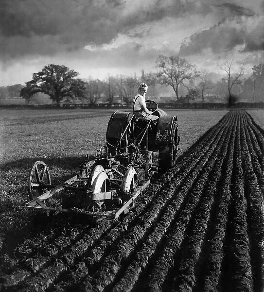 Land girl plowing field with tractor in Berkshire MSI WW2