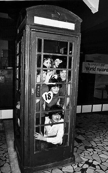 Twenty people set a record for squeezing into a telephone box