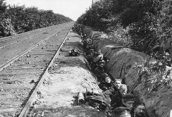 World War One - Belgian troops wait in a trench beside a railway line as they advance
