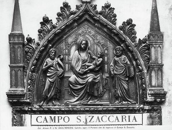 Madonna and Child with St. John the Baptist and St. Mark, lunette above the doorway leading to Campo San Zaccaria in Venice