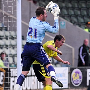 Bristol Citys Neil Kilkenny challenges Plymouth goalkeeper