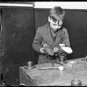 Boy Repairs Boots / 1930