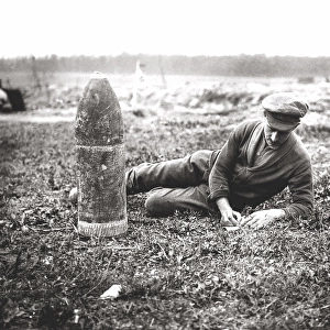 British soldier writing home next to bombshell, WW1