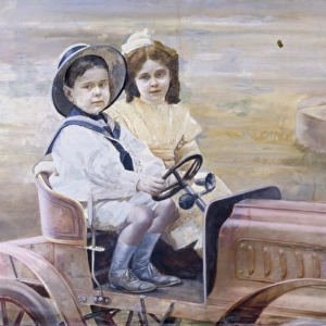 Brother and sister in a toy vintage car