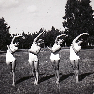 Four female gymnasts in row
