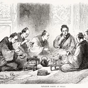 Japanese people sitting on the floor eating their meal using small bowls and chopsticks