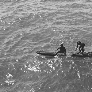 Native boatmen with canoes