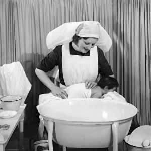 Nurse dries baby after bath
