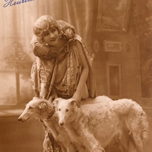 Studio portrait, elegant woman with two dogs, France