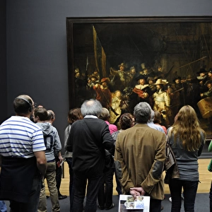 Visitors looking at The Night Watch by Rembrandt (1606-1669)