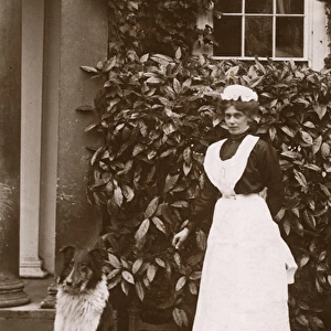 Woman with collie dog in a garden