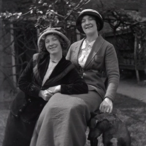 Two women posing in a garden