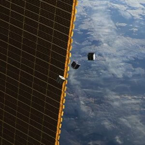 Satellites and ISS solar panel in space