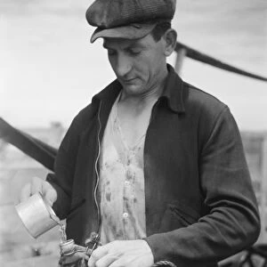 Sheepherder filling water bag, 1939