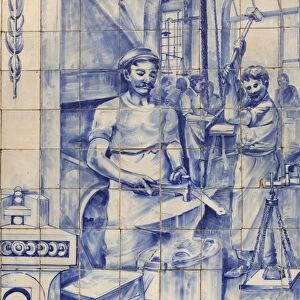 A blacksmiths workshop depicted on traditional Portuguese Azulejo tiles on a building in Alfama, Lisbon, Portugal, Europe