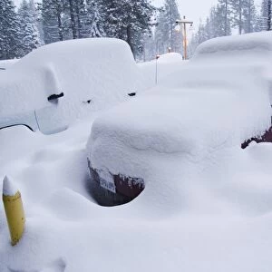 Cars under heavy snow fall at the winter ski resort