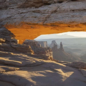 Close up view of canyon through Mesa Arch with glowing arch, Canyonlands National Park