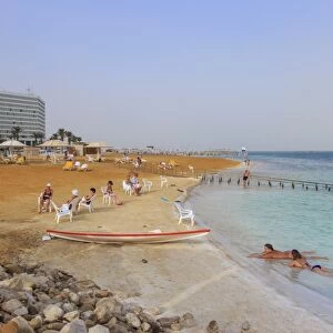 Ein Bokek (En Boqeq) beach, with bathers in the turquoise sea and relaxing ashore
