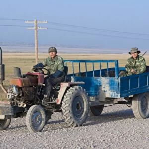 Farmers working with tractor, Sary Tash, Kyrgyzstan, Central Asia