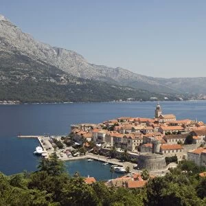 Hilltop view of red tile rooftops of medieval Old Town and Bay, Korcula Island