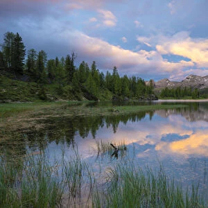 Pristine alpine Lake Federa and Becco di Mezzodi mountain lit by sunset