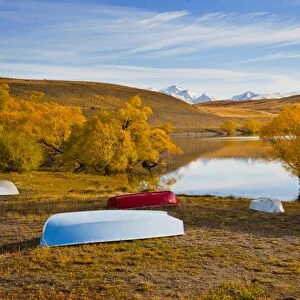 Rowing boats and snow capped mountains at Lake Alexandrina, Southern Lakes, Otago Region, South Island, New Zealand, Pacific