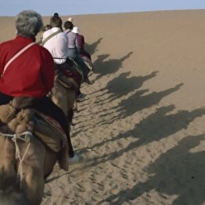Shadows of tourists on camels, Dunhuang Province, China, Asia