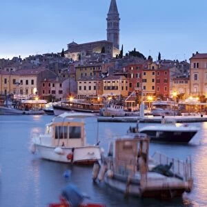 Ships and boats in the harbour and the old town with cathedral of St. Euphemia at dusk, Rovinj, Istria, Croatia, Europe