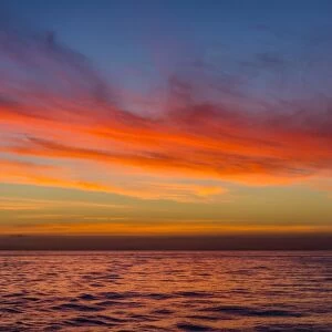 Sunrise off the coast of Akaroa, South Island, New Zealand, Pacific