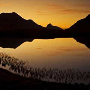 Sunset silhouette at Lochan an Ais, Inverpolly, Sutherland, north west Scotland