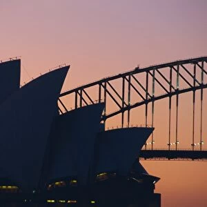 Sydney Opera House and Harbour Bridge silhouetted together at sunset, Sydney