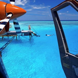 View from a seaplane cockpit of man swimming, Maldives, Indian Ocean, Asia