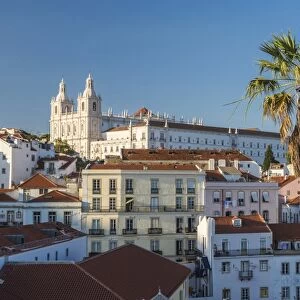 View of terracotta roofs and the ancient castle and dome from Miradouro Alfama viewpoint