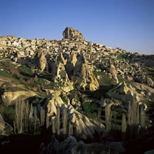 View of Uchisar with houses carved in conical rock formations