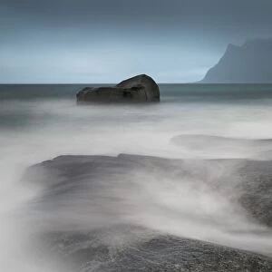 Water breaks over rocks at Uttakleiv, Lofoten Islands, Arctic, Norway, Scandinavia, Europe