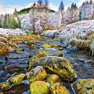 A winter view of the flowing water and colourful rocks of the River Polloch in the
