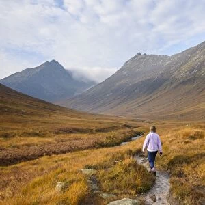 Woman walking in Glen Sannox, Isle of Arran, North Ayrshire, Scotland, United Kingdom