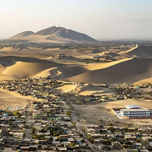 City of Ica amidst sand dunes seen from Huacachina, Ica Region, Peru