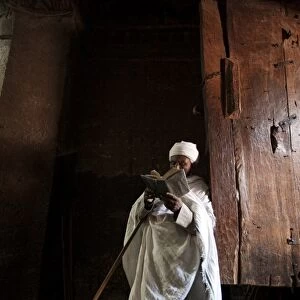 Ethiopia, Lalibela. A priest in one of the ancient rock-hewn churches of Lalibela