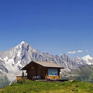France, Rhone Alps, Chamonix Valley, hikers resting at a mountain hut with Les Dru mountains
