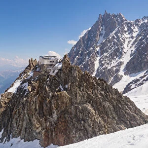 Les Grand Mulets alpine refuge over a rock in Mount Blanc north side over glacier