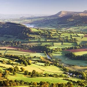 Morning sunshines illuminates the patchwork fields in the Usk Valley, looking towards