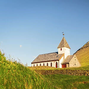 Traditional church facing the ocean at sunset, Vidareidi, Vidoy island, Faroe islands, Denmark